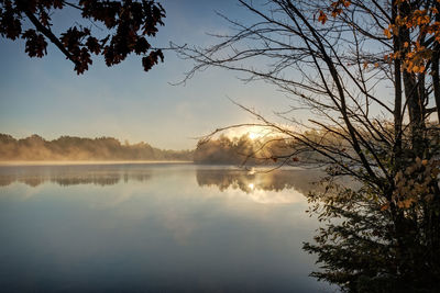 Scenic view of lake against sky at sunset