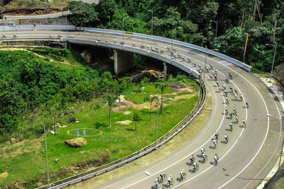 High angle view of people doing bicycles racing on bridge