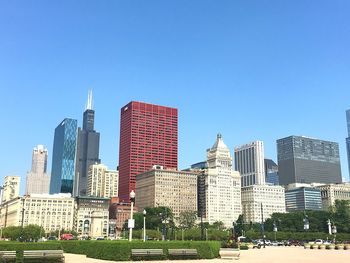 Low angle view of skyscrapers against blue sky