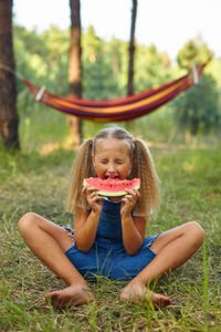 Portrait of boy playing with toy on field