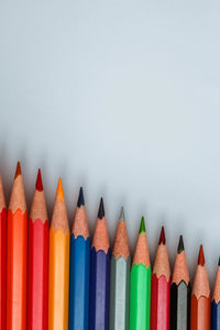 Close-up of multi colored pencils against white background