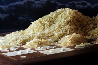 Close-up of raw rice on chess board