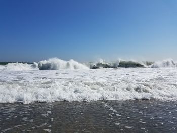 Scenic view of sea against clear blue sky