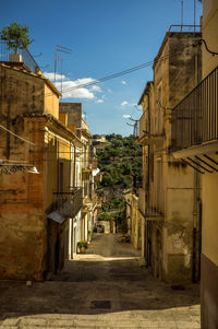 Empty alley amidst buildings in city