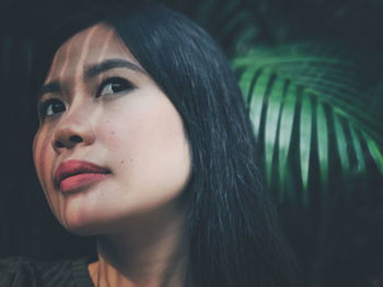 Close-up of young woman thinking