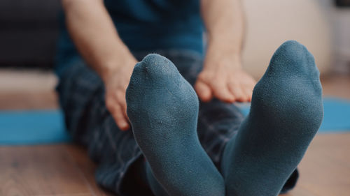 Low section of woman sitting on floor