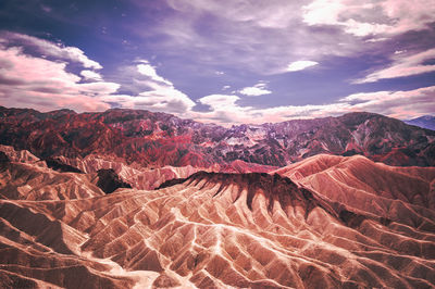 Aerial view of mountain range against cloudy sky