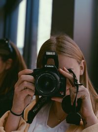 Portrait of woman photographing