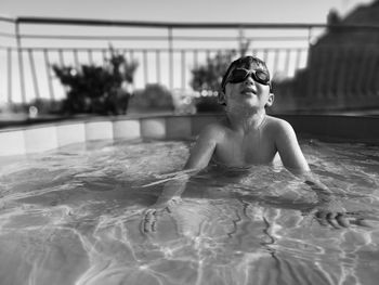 Portrait of cute boy swimming in pool