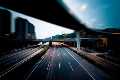 Blurred motion of highway against sky in city