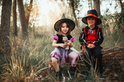 Portrait of happy friends sitting on land