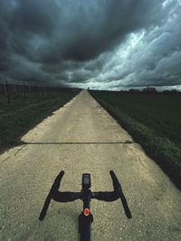 Shadow of man walking on road against sky