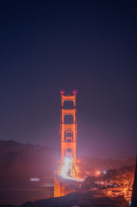 Illuminated building against sky at night