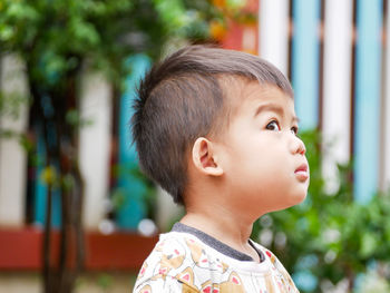 Close-up of cute boy looking away