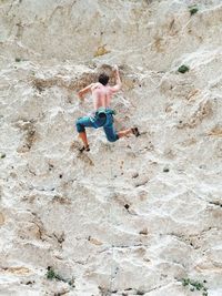 Full length of baby boy on rock