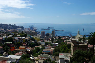 High angle view of townscape by sea against sky