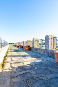 Bridge over river against clear blue sky