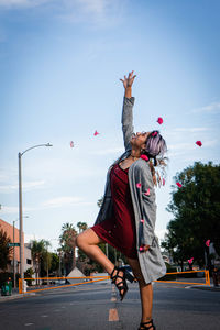Rear view of man and woman on road against sky
