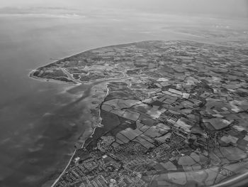 Aerial view of sea seen through airplane window