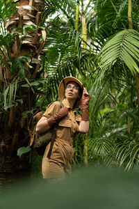 Young woman hiking against trees in forest