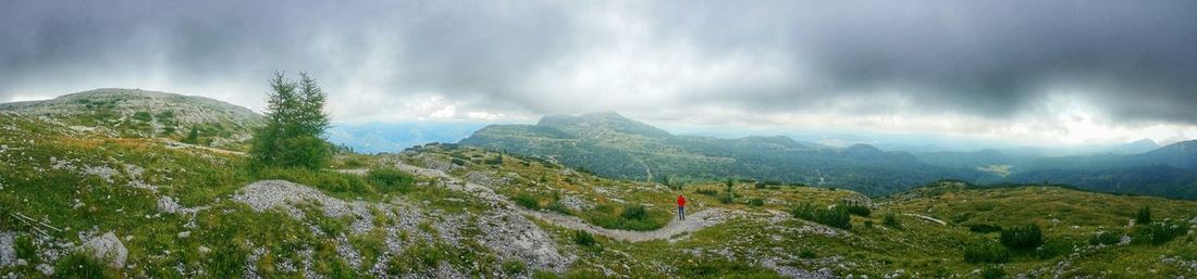 Scenic view of mountains against cloudy sky