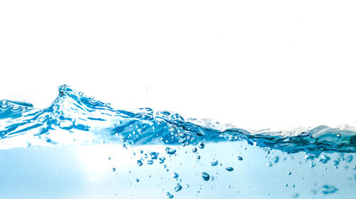 Close-up of water splashing against white background