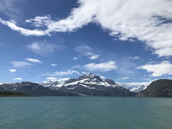 Scenic view of lake and snowcapped mountains against sky