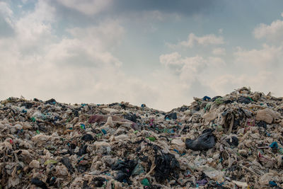 Stack of garbage against sky