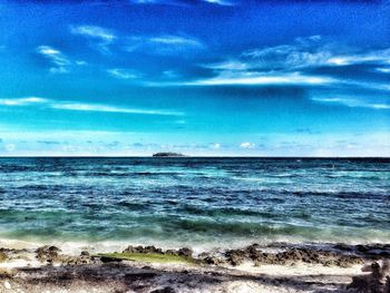 Scenic view of sea against blue sky