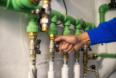 A male plumber opening a water valve