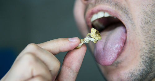 Close-up of man eating food