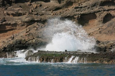 Scenic view of sea waves splashing on rocks