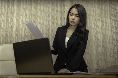 Mid adult man using laptop on table