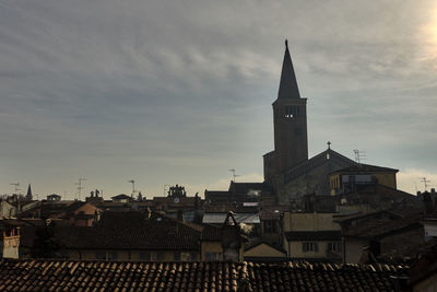 Buildings in town against sky