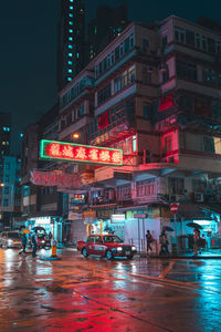 Illuminated city street and buildings at night