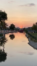 Scenic view of river against sky at sunset