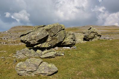 View of the norber erratics in yorkshire dales against stormy sky.