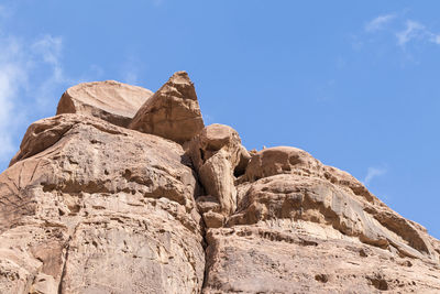 Low angle view of rock formation against sky