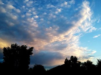 Low angle view of silhouette trees against sky during sunset