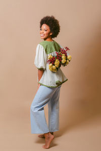 Portrait of smiling young woman holding bouquet