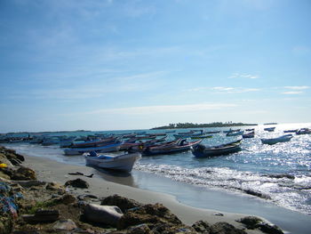 Boats moored on sea against sky