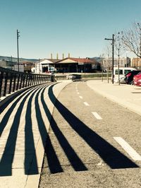 Empty road with buildings in background