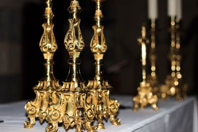 Close-up of candlestick holders on altar