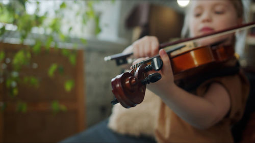 Midsection of man playing violin