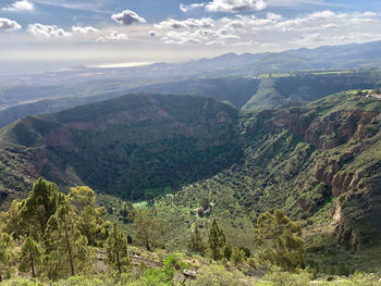Aerial view of valley and mountains against sky