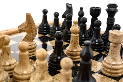 Close-up of chess pieces against white background