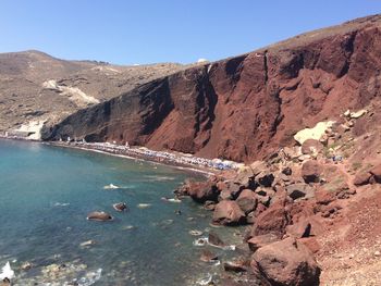 Red beach in santorini against sky