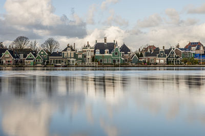 Panoramic view of lake and buildings against sky