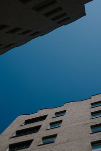 Low angle view of building against clear blue sky