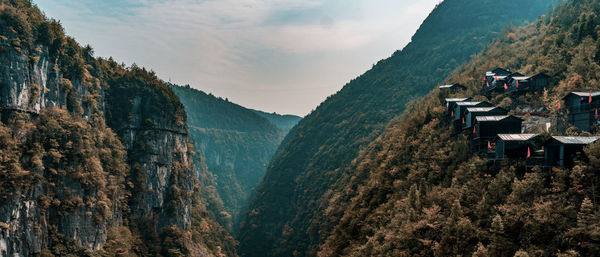 Panoramic view of trees and mountains against sky